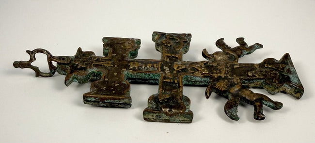 17th-century Spanish bronze Cruz de Caravaca with elaborate religious reliefs, surviving silver-coloured finish, and natural green and turquoise oxidation.