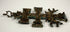 17th-century Spanish bronze Cruz de Caravaca with elaborate religious reliefs, surviving silver-coloured finish, and natural green and turquoise oxidation.