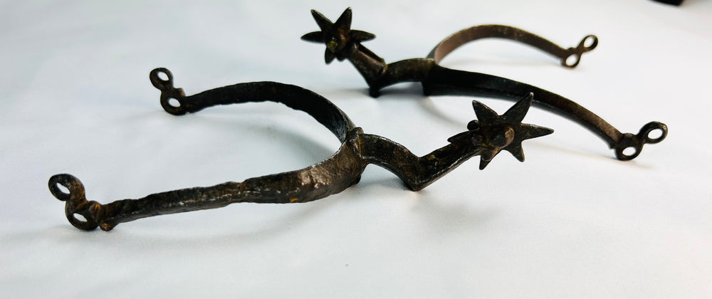 Close view of German star-rowel spurs forged in the 1500s–1600s