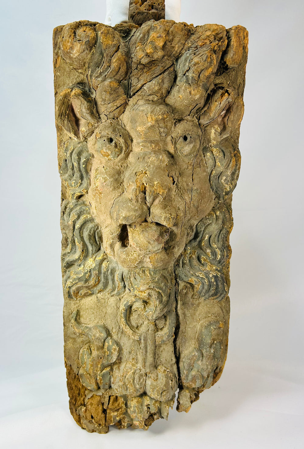 17th–18th century European Baroque lion corbel with swirling mane, traces of blue-grey paint and gilding