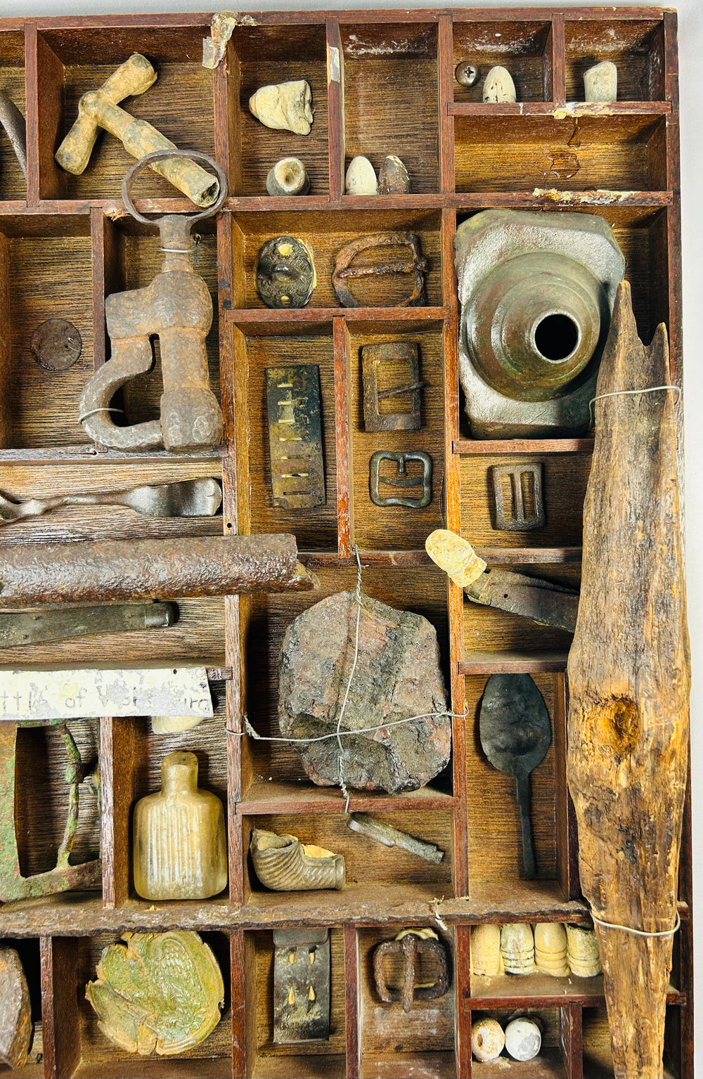 American Civil War battlefield relic collection in wooden shadow-box with ammunition, uniform hardware, brass pieces, and miscellaneous dug items.