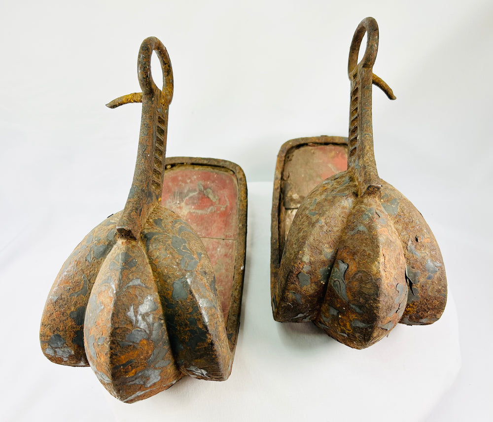 Edo period Japanese abumi stirrups featuring broad scooped treads, triple-lobed toe guards, and ladder-slotted risers, circa late 18th–19th century.