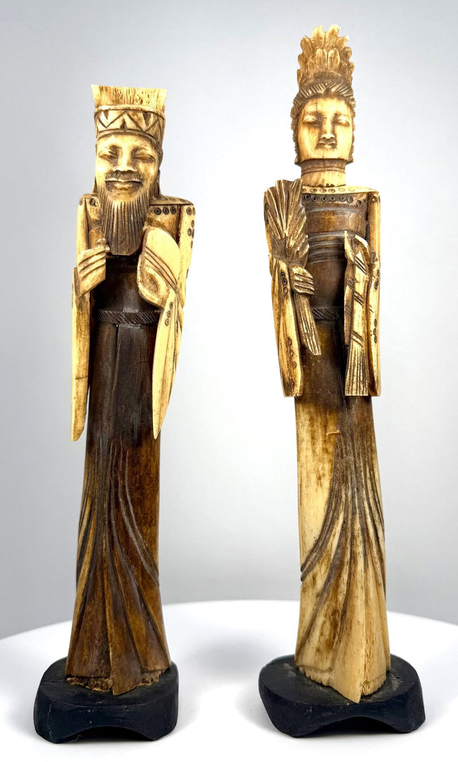Chinese Emperor figurine with geometric headdress patterns, decorative shoulder ornaments, and deeply incised folds along its dark-stained robe.
