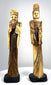 Chinese Emperor figurine with geometric headdress patterns, decorative shoulder ornaments, and deeply incised folds along its dark-stained robe.