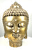 Golden metal Buddha head sculpture featuring a prominent urna on the forehead, rounded cheeks, and a peaceful meditative expression.