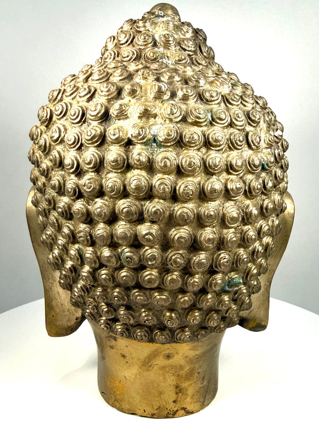 Asian Buddhist metal sculpture displaying rows of tightly arranged hair curls extending across the crown and surrounding the raised ushnisha.