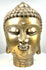 Vintage Asian Buddhist Buddha head statue displaying gently lowered almond-shaped eyes, arched eyebrows, and delicately sculpted facial features.