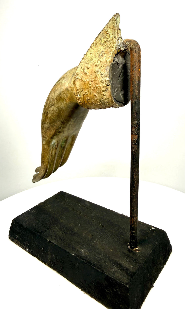 Antique Thai Buddhist hand sculpture displaying finely defined finger contours, a decorative palm emblem, and localized greenish copper oxidation.