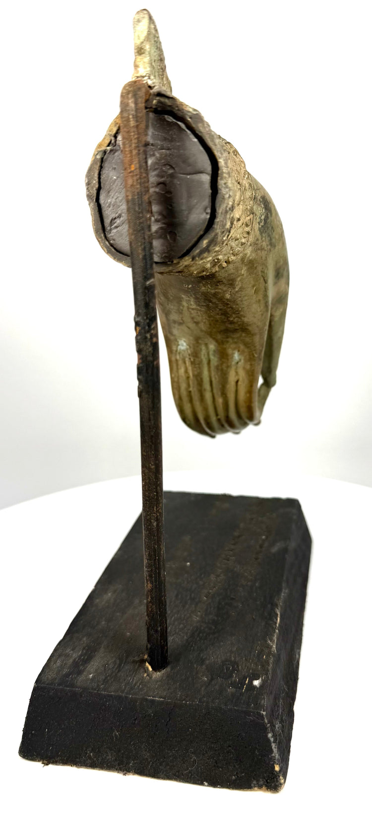 19th-century bronze Buddhist sculpture featuring intricate floral decoration, a pointed ornamental wrist cuff, and surviving gold-toned surface highlights.