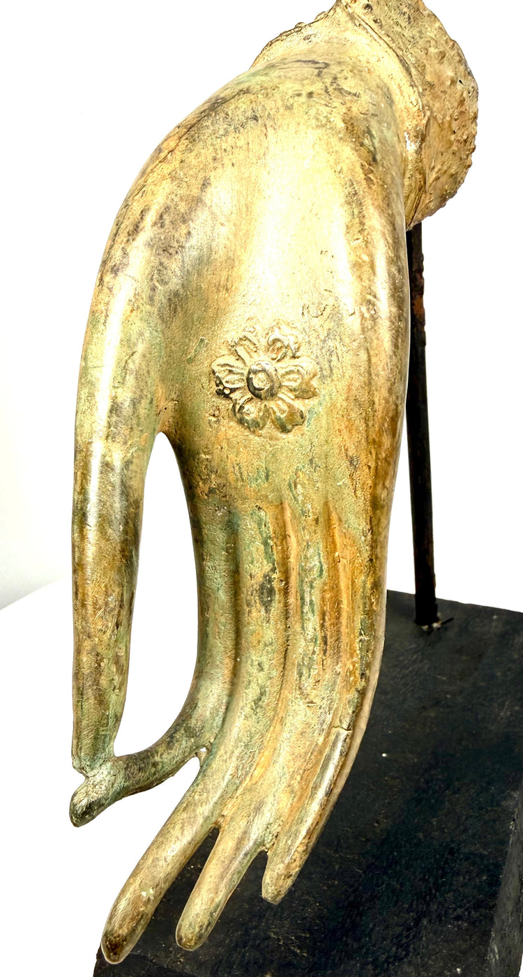 19th-century Southeast Asian bronze sculpture displaying naturalistic finger contours, intricate palm decoration, and warm golden patination with green oxidation.