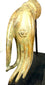 19th-century Southeast Asian bronze sculpture displaying naturalistic finger contours, intricate palm decoration, and warm golden patination with green oxidation.