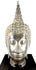 Thai Sukhothai-style Buddha sculpture with elongated downcast eyes expressing peaceful meditation and spiritual tranquillity.