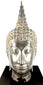 Thai Sukhothai-style Buddha sculpture with elongated downcast eyes expressing peaceful meditation and spiritual tranquillity.