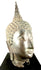 Traditional Thai Buddhist sculpture featuring extended earlobes, smooth facial contours, and a peaceful expression.