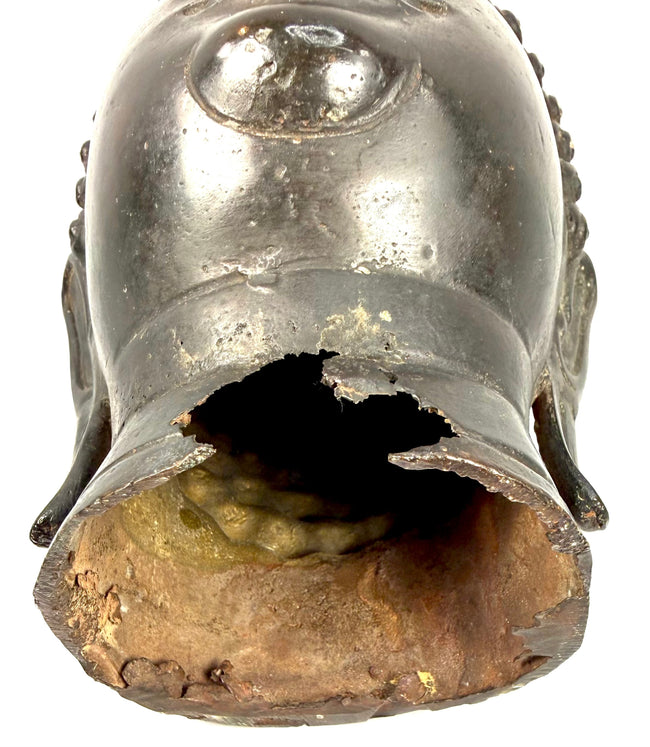Thai Sukhothai-style Buddha head with exposed interior casting material, surface abrasions, and historic patination.