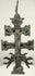 Historic Cross of Caravaca featuring two winged angels with outstretched wings, detailed sculptural forms, and turquoise copper oxidation.
