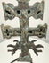 Spanish bronze devotional pendant with an elongated suspension loop, raised Christian figures, and intricate ornamentation along the central shaft.