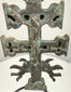 Spanish bronze devotional pendant with an elongated suspension loop, raised Christian figures, and intricate ornamentation along the central shaft.