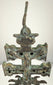 Antique Caravaca crucifix displaying the Virgin Mary beneath the Crucifixion, surrounded by decorative relief and aged bronze patination.