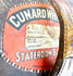 Early 20th-century leather top hat travelling case featuring an oval construction, stitched panels, and aged brown leather.