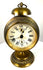 Early 20th-century Jahresuhrenfabrik alarm clock from Triberg, Germany, with decorative brass housing and an elevated pedestal base.