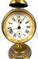 Jahresuhrenfabrik alarm clock displaying the diamond-shaped J–UF manufacturer's trademark on its aged cream-coloured dial.