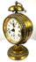 German Black Forest mechanical alarm clock displaying a cream-coloured dial, bold Roman numerals, and traditional black metal hands.