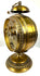 Antique German brass alarm clock with mechanical winding controls, engraved adjustment indicators, and traditional metal construction.