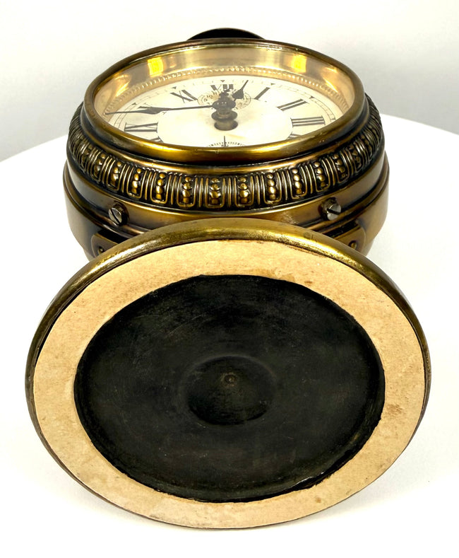 Antique Jahresuhrenfabrik brass clock displaying natural oxidation, surface wear, decorative metalwork, and historic mechanical components.