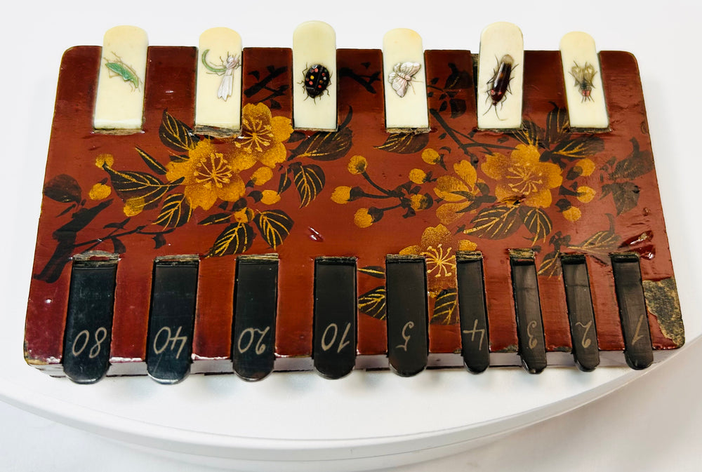 Japanese lacquer framed art with gold floral design and inset insect detail tabs