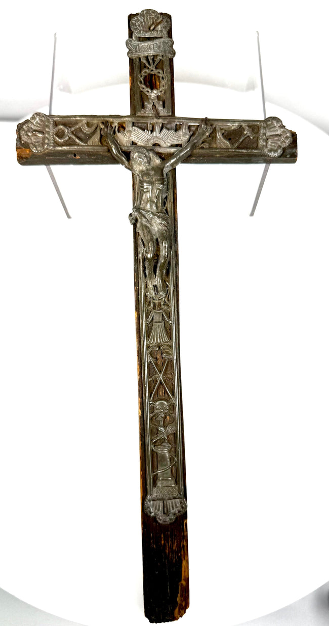 Arma Christi religious symbols arranged along the wooden cross, depicting instruments associated with the Passion of Christ.