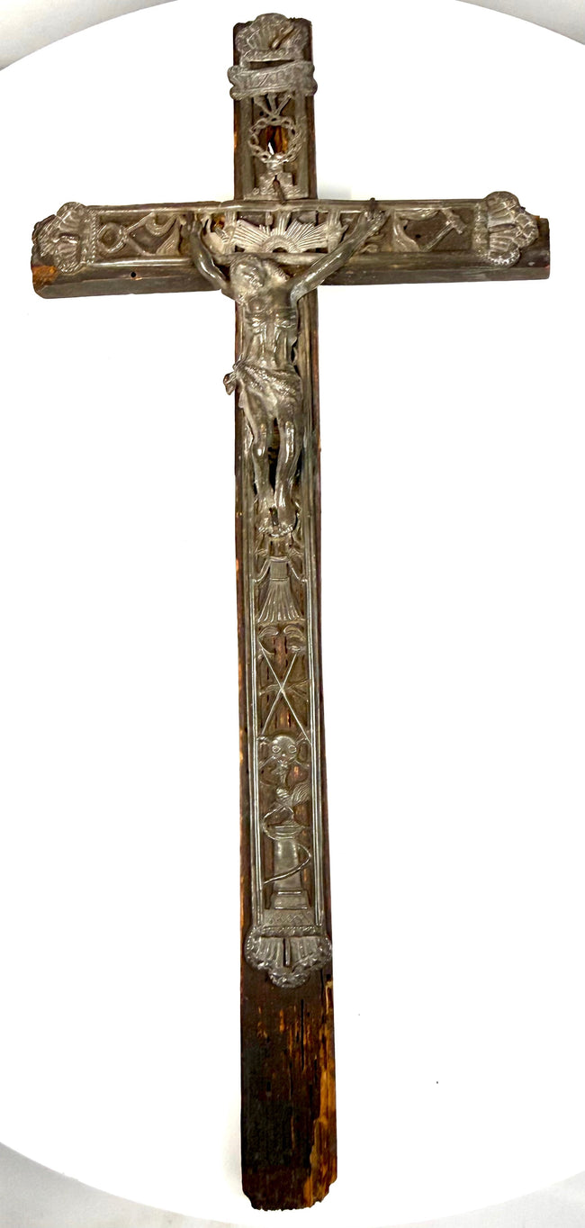 Embossed lead Corpus Christi figure with outstretched arms, bowed head, and radiating sunburst on an 18th-century French crucifix.
