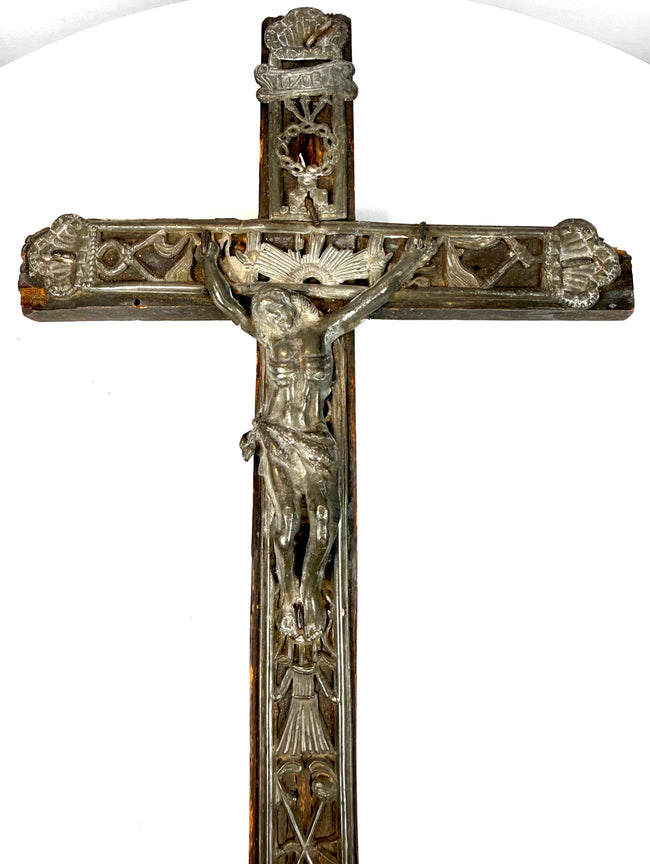 18th-century French peddler’s crucifix with embossed lead religious figures mounted on a dark-painted pine wooden cross.