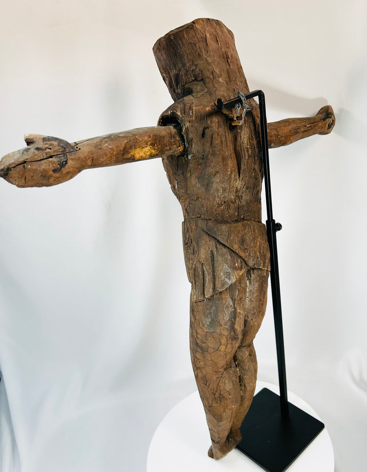 Early religious sculpture of Christ with carved detail and historic wear