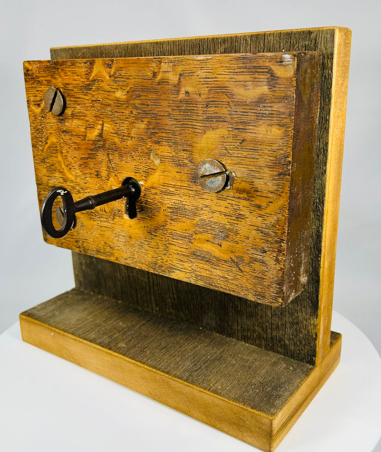 Historical mortise lock with skeleton key and aged patina on wood housing