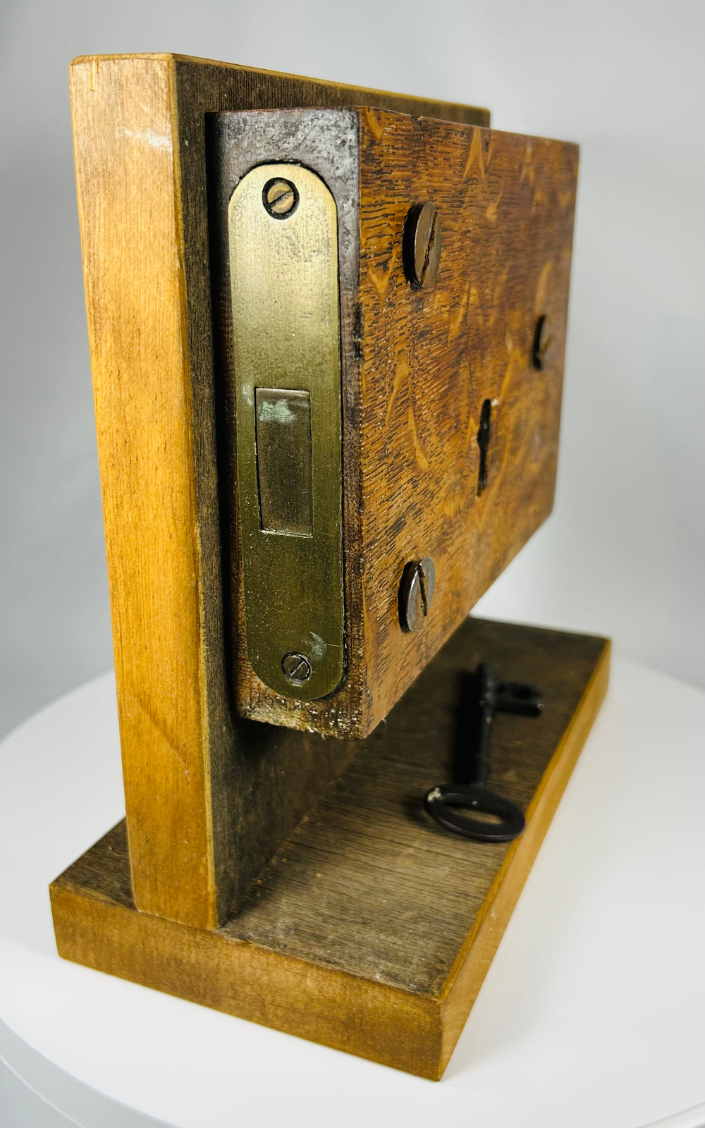 Mounted antique lock mechanism with visible keyhole escutcheon and hardware