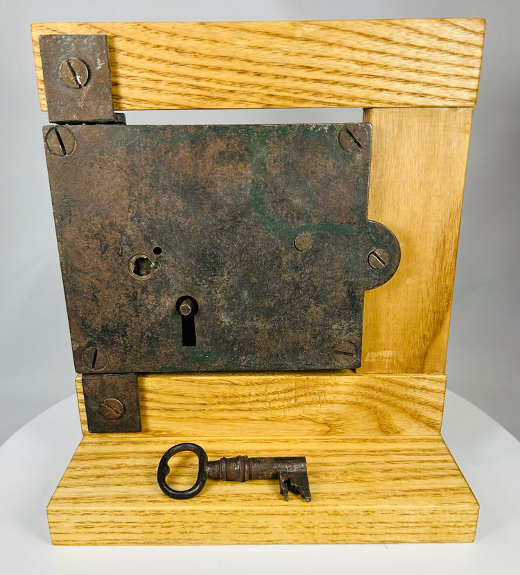 Hand-forged iron rim lock with matching key and aged surface patina