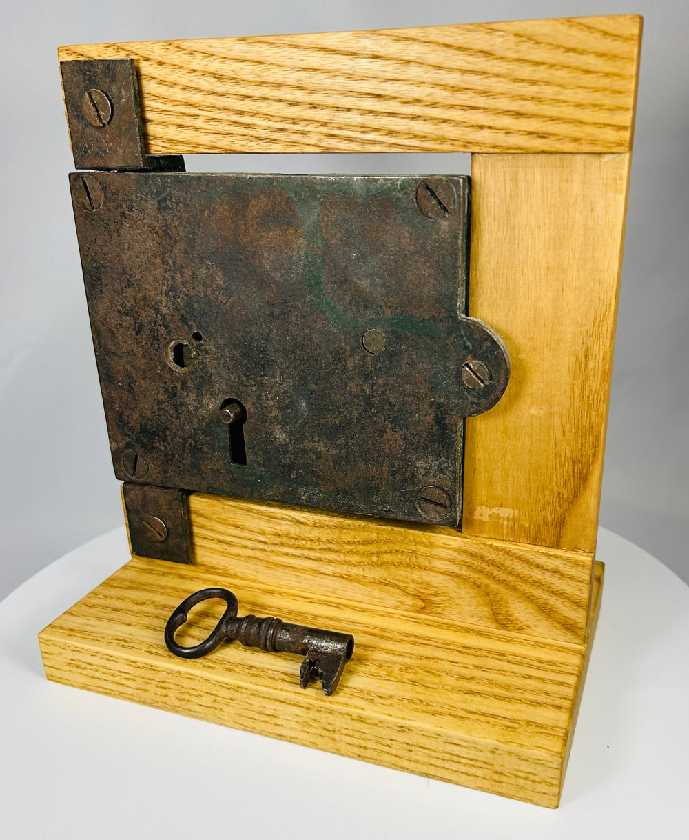 Antique iron lock with visible screws and worn painted reverse surface