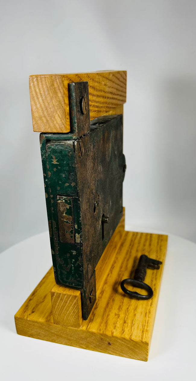 19th century architectural lock with iron key and aged painted backing