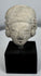 Pre-Columbian ceramic effigy head with elongated skull shape and archaeological surface patina.