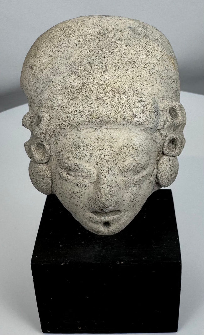 Terracotta human head from the Colima, Jalisco, or Nayarit region mounted on a custom display stand.