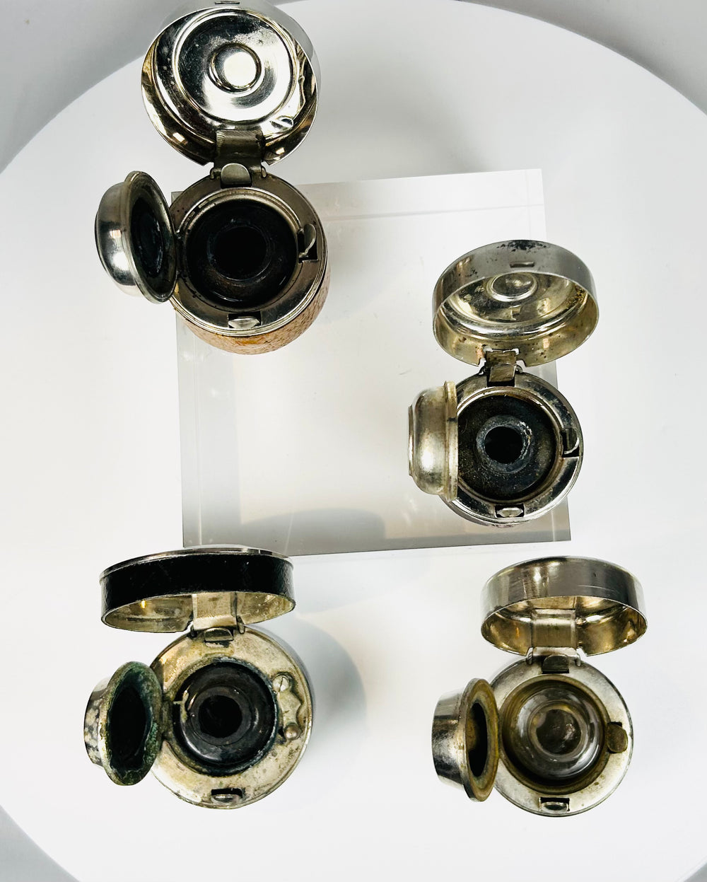 Antique writing tools with glass reservoirs and protective metal tops