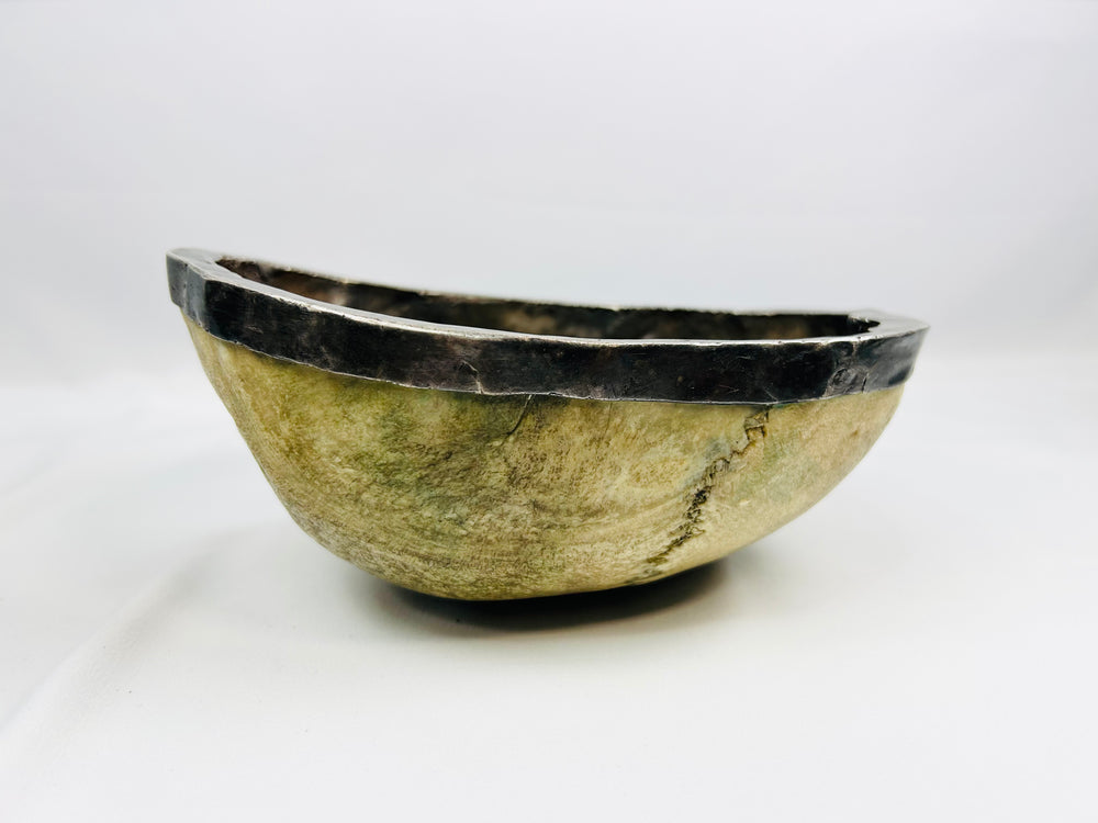 19th-century Tibetan Kapala ritual skull cup showing human bone bowl with silver rim, used in Tantric Buddhist ceremonies.