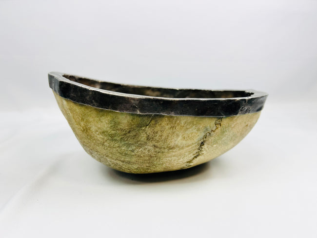 19th-century Tibetan Kapala ritual skull cup showing human bone bowl with silver rim, used in Tantric Buddhist ceremonies.