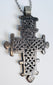Handcrafted Ethiopian Coptic devotional cross pendant with pierced lattice pattern and suspension loop.