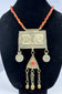 Central Asian Turkmen ceremonial necklace featuring silver-toned metal, coin pendants, and a triangular tumar pendant.
