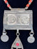 Late 19th-century Turkmen tribal necklace with Arabic coin motifs, red glass cabochon, and dangling chain ornaments.