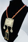 Traditional Turkmen necklace showcasing a large pectoral ornament, geometric decoration, and protective tumar amulet.