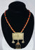 Historic Turkmen tribal necklace displaying traditional Central Asian jewelry with coin elements, red glass accents, and ornate metalwork.