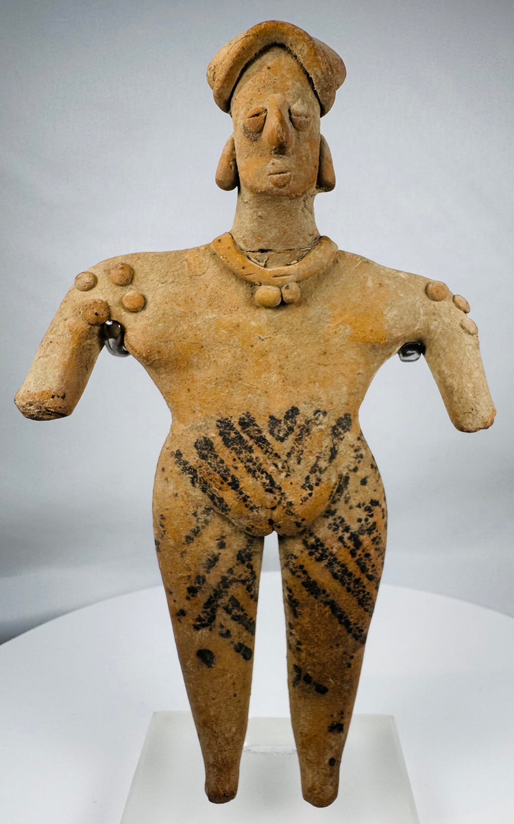 Pre-Columbian Colima female pottery figure featuring applied jewelry, black pigment motifs, and a custom display stand.